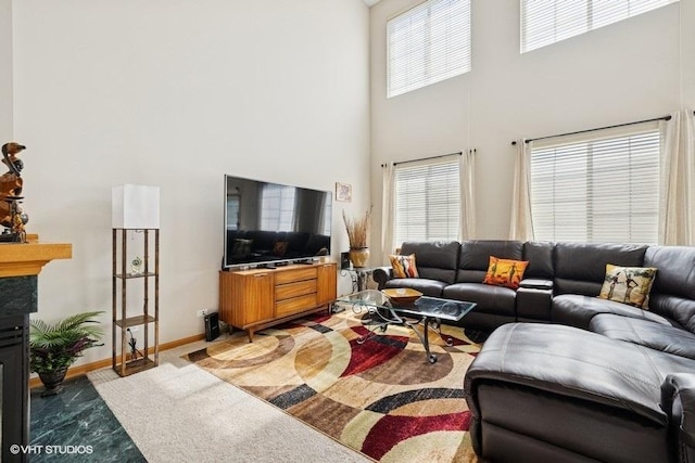 711 Creekside Cir Unit 711, Gurnee, IL 60031 - living area with a towering ceiling, a glass covered fireplace, and carpet