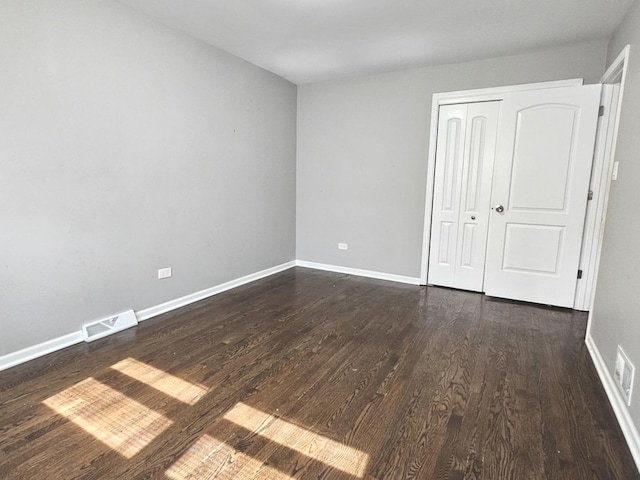 678 Muskegon Ave, Calumet City, IL 60409 - unfurnished bedroom with dark wood-style floors and a closet