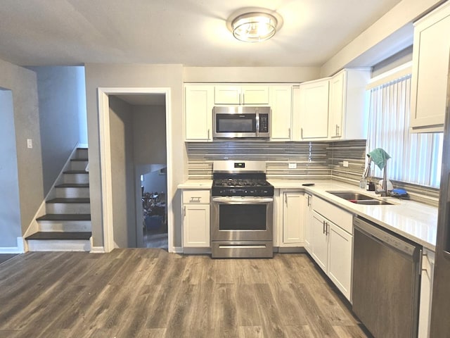 678 Muskegon Ave, Calumet City, IL 60409 - kitchen with stainless steel appliances, backsplash, light countertops, and wood finished floors