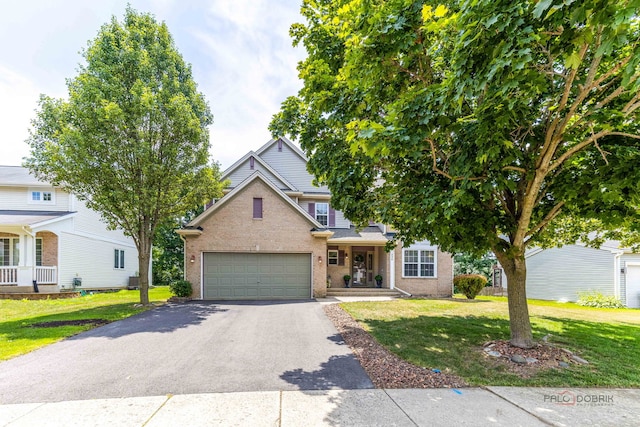 330 Greenview Ln, Lake Villa, IL 60046 - traditional-style house featuring brick siding, driveway, and a front lawn