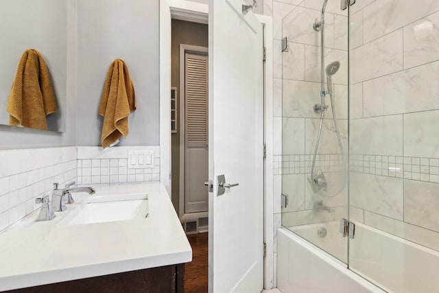 700 W Cornelia Ave Unit 3E, Chicago, IL 60657 - bathroom featuring bath / shower combo with glass door, vanity, and wood finished floors