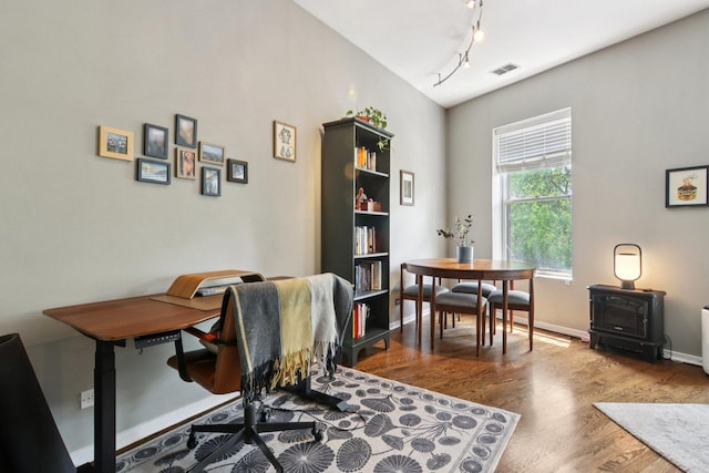 700 W Cornelia Ave Unit 3E, Chicago, IL 60657 - home office featuring wood finished floors, a wood stove, and track lighting