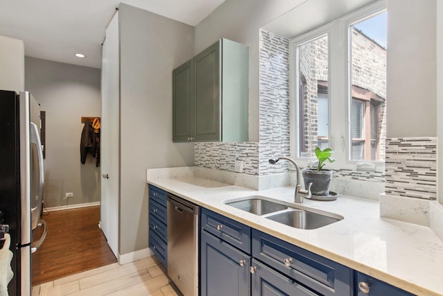 700 W Cornelia Ave Unit 3E, Chicago, IL 60657 - kitchen with appliances with stainless steel finishes, light wood-style flooring, backsplash, recessed lighting, and blue cabinetry