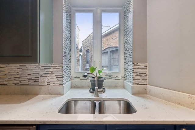 700 W Cornelia Ave Unit 3E, Chicago, IL 60657 - kitchen with healthy amount of natural light, tasteful backsplash, and light stone counters