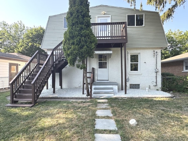 428 W Williams St, Kankakee, IL 60901 - back of house featuring stairway, a yard, and stucco siding