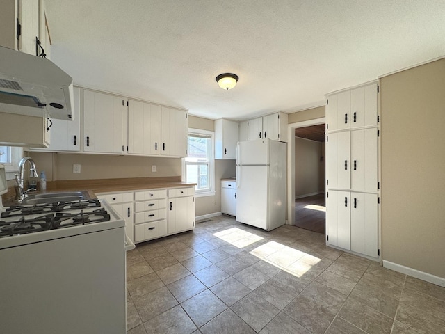 428 W Williams St, Kankakee, IL 60901 - kitchen with white appliances, extractor fan, a textured ceiling, and white cabinets