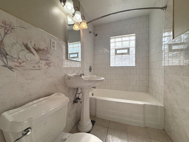 428 W Williams St, Kankakee, IL 60901 - bathroom with tile patterned floors, tile walls, healthy amount of natural light, and tub / shower combination