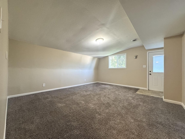 428 W Williams St, Kankakee, IL 60901 - spare room featuring vaulted ceiling, carpet floors, and a textured ceiling