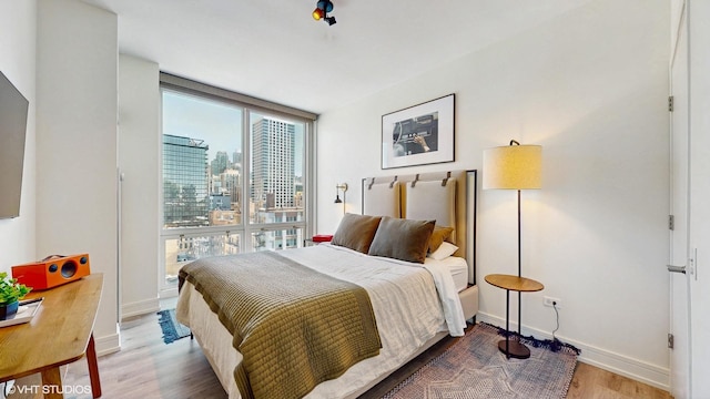 757 N Orleans St Unit 907, Chicago, IL 60654 - bedroom featuring wood finished floors and a city view