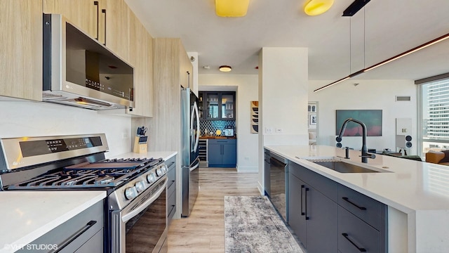757 N Orleans St Unit 907, Chicago, IL 60654 - kitchen with stainless steel appliances, light wood-type flooring, light countertops, open floor plan, and light brown cabinets