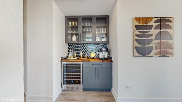 757 N Orleans St Unit 907, Chicago, IL 60654 - indoor bar featuring wine cooler, light wood finished floors, and backsplash