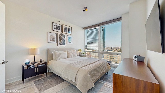 757 N Orleans St Unit 907, Chicago, IL 60654 - bedroom with a wall of windows and wood finished floors