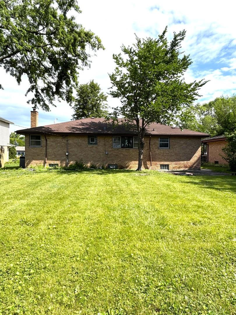 6733 W 88th St, Oak Lawn, IL 60453 - rear view of property with a yard, a chimney, and brick siding