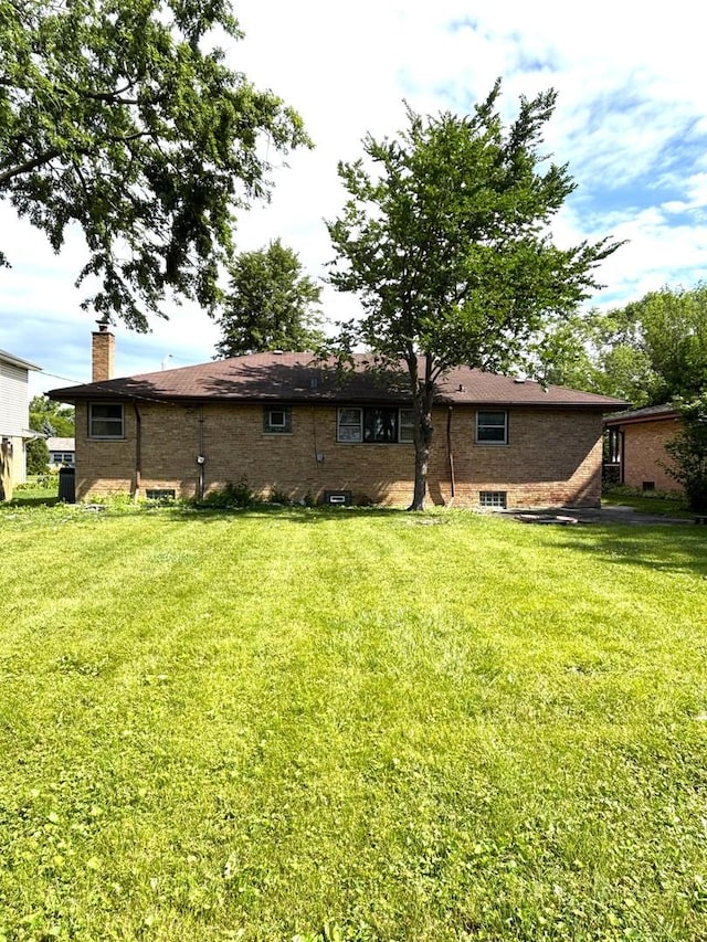 6733 W 88th St, Oak Lawn, IL 60453 - rear view of property with a yard, a chimney, and brick siding