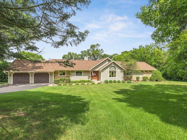12828 Menominee Trl, Roscoe, IL 61073 - single story home featuring a chimney, an attached garage, a front lawn, and asphalt driveway