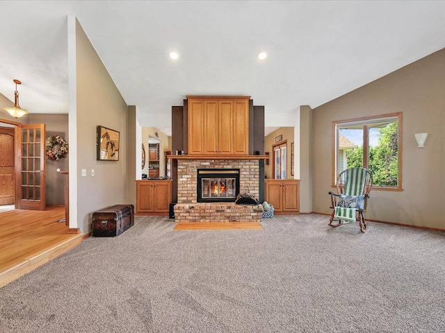 12828 Menominee Trl, Roscoe, IL 61073 - living room featuring vaulted ceiling, light colored carpet, a fireplace, and recessed lighting