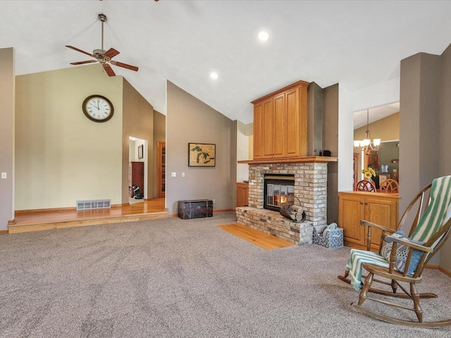 12828 Menominee Trl, Roscoe, IL 61073 - carpeted living area with a chandelier, a brick fireplace, ceiling fan, high vaulted ceiling, and recessed lighting
