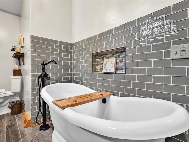 12828 Menominee Trl, Roscoe, IL 61073 - full bathroom featuring tile walls, a freestanding tub, and wood finished floors