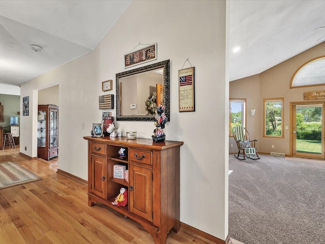 12828 Menominee Trl, Roscoe, IL 61073 - hallway with lofted ceiling and light wood finished floors