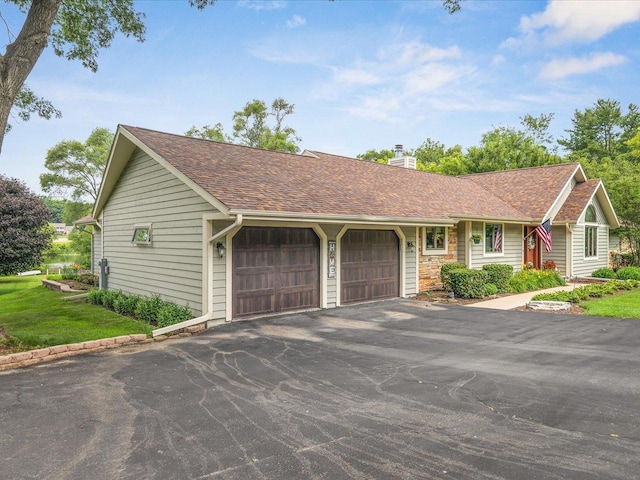12828 Menominee Trl, Roscoe, IL 61073 - single story home with a chimney, a shingled roof, a garage, and a front lawn
