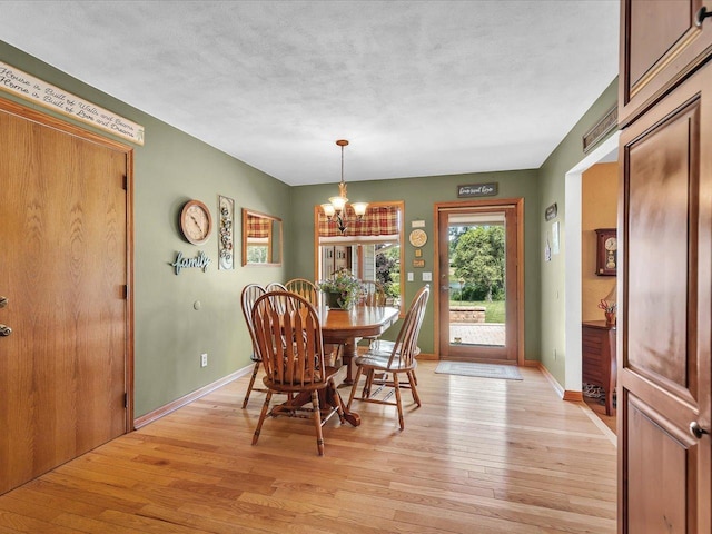 12828 Menominee Trl, Roscoe, IL 61073 - dining space featuring light wood finished floors and a chandelier