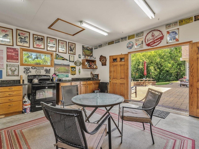 12828 Menominee Trl, Roscoe, IL 61073 - dining area featuring concrete floors, attic access, wine cooler, and bar area