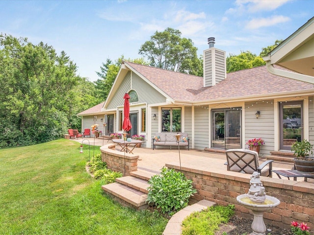 12828 Menominee Trl, Roscoe, IL 61073 - rear view of property with a yard, a chimney, a patio, and roof with shingles