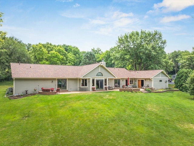 12828 Menominee Trl, Roscoe, IL 61073 - rear view of house featuring a patio area, a yard, and a chimney