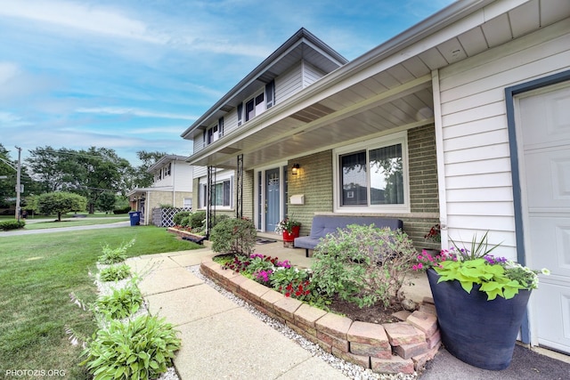 445 Kinkaid Ct, Des Plaines, IL 60016 - entrance to property featuring a yard, brick siding, and covered porch