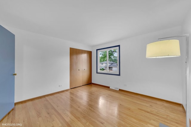 445 Kinkaid Ct, Des Plaines, IL 60016 - unfurnished bedroom with wood finished floors and a closet