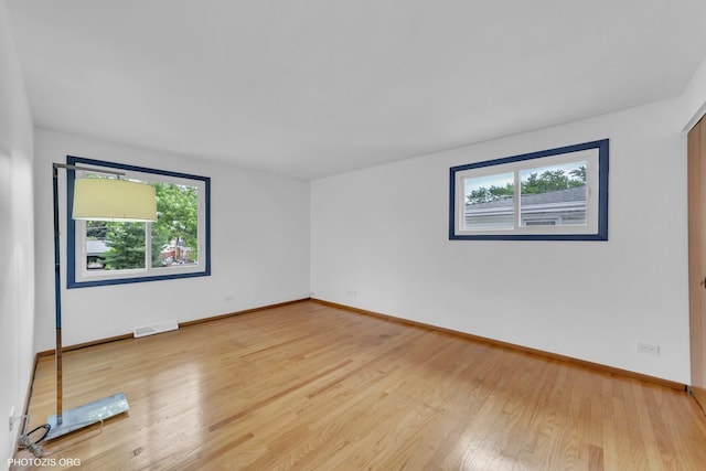 445 Kinkaid Ct, Des Plaines, IL 60016 - empty room featuring healthy amount of natural light and light wood-style floors