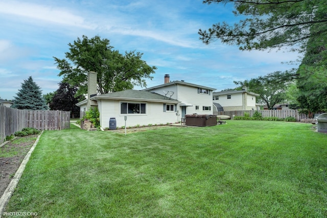 445 Kinkaid Ct, Des Plaines, IL 60016 - rear view of house featuring a hot tub, a fenced backyard, and a chimney