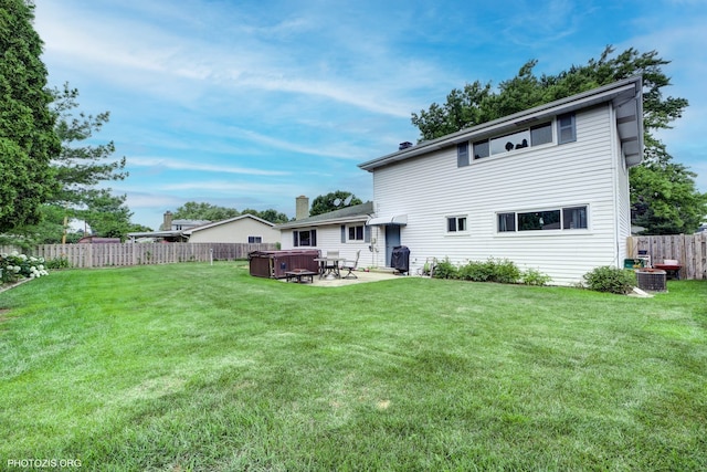 445 Kinkaid Ct, Des Plaines, IL 60016 - back of property with a hot tub, a fenced backyard, and a patio area