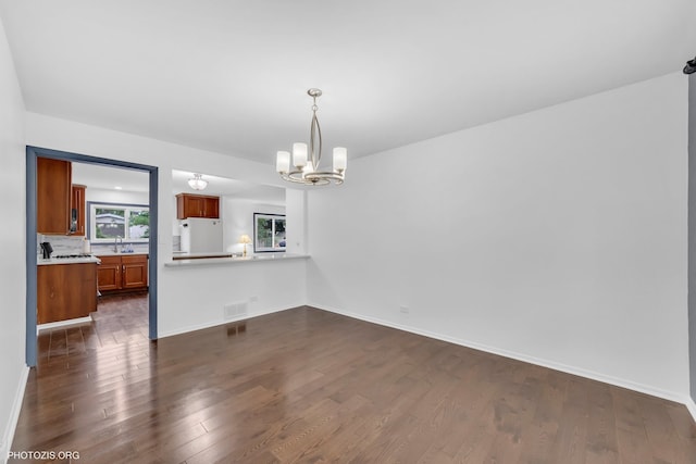 445 Kinkaid Ct, Des Plaines, IL 60016 - unfurnished dining area featuring a chandelier and dark wood-style floors