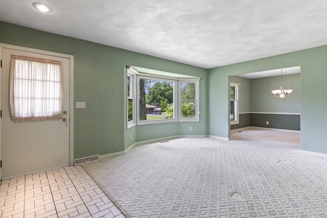 1485 Bryn Mawr Ln, Rockford, IL 61107 - empty room with a chandelier and carpet floors