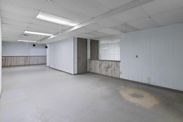 1485 Bryn Mawr Ln, Rockford, IL 61107 - spare room with a drop ceiling, finished concrete flooring, and wooden walls
