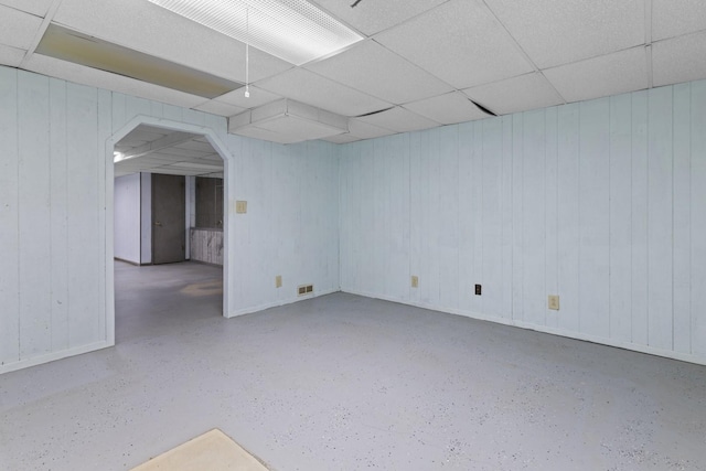 1485 Bryn Mawr Ln, Rockford, IL 61107 - empty room with arched walkways, speckled floor, wooden walls, and a paneled ceiling