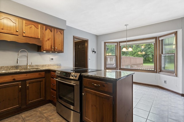 1485 Bryn Mawr Ln, Rockford, IL 61107 - kitchen featuring stainless steel electric range oven, a peninsula, light tile patterned floors, dark stone countertops, and decorative light fixtures