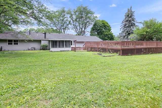 1485 Bryn Mawr Ln, Rockford, IL 61107 - back of house featuring a sunroom, a yard, and a wooden deck