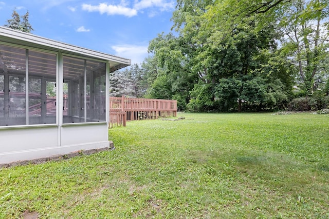 1485 Bryn Mawr Ln, Rockford, IL 61107 - view of grassy yard featuring a sunroom and a wooden deck