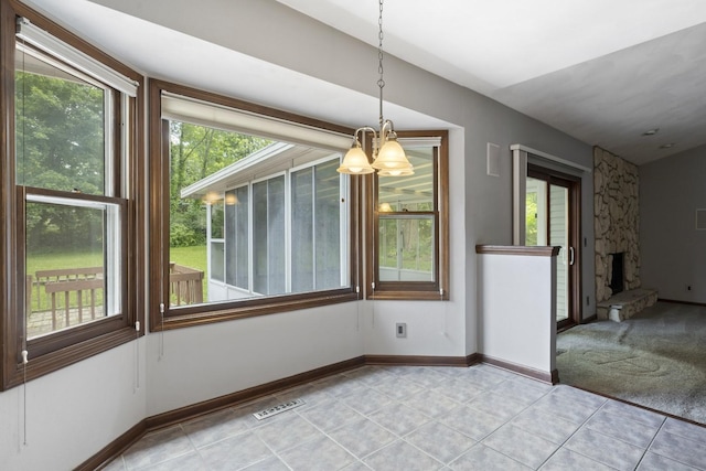 1485 Bryn Mawr Ln, Rockford, IL 61107 - unfurnished dining area with plenty of natural light, a chandelier, and light tile patterned flooring