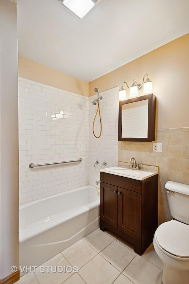 7241 N Mcvicker Ave, Chicago, IL 60646 - bathroom with tile patterned flooring, tub / shower combination, vanity, and tile walls