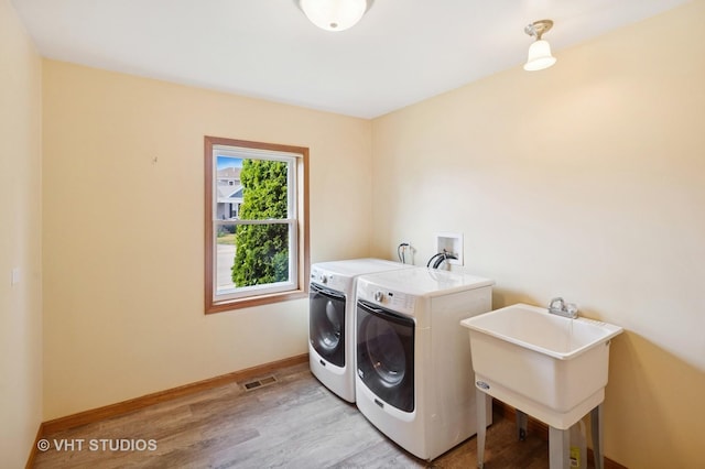 7241 N Mcvicker Ave, Chicago, IL 60646 - laundry area featuring independent washer and dryer and light wood-style flooring