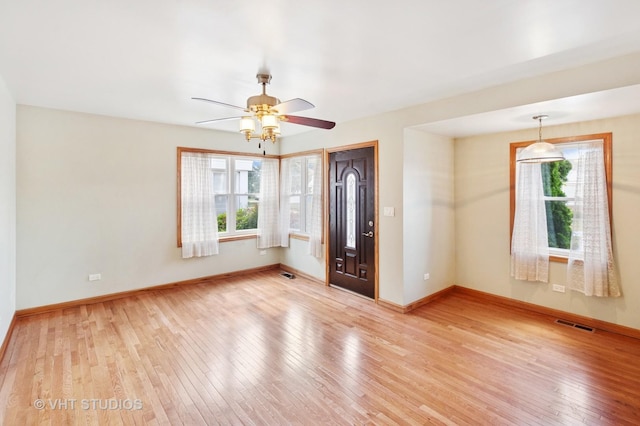 7241 N Mcvicker Ave, Chicago, IL 60646 - foyer entrance featuring healthy amount of natural light, light wood finished floors, and ceiling fan