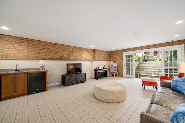 2131 W Schiller St, Chicago, IL 60622 - living room featuring brick wall, light tile patterned floors, and recessed lighting