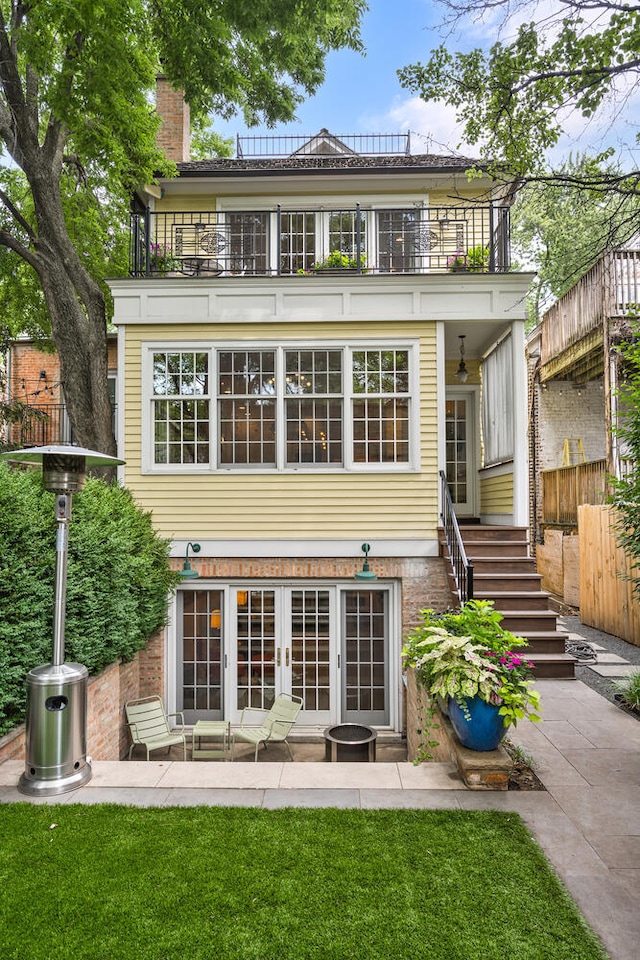 2131 W Schiller St, Chicago, IL 60622 - rear view of property featuring a balcony, french doors, stairs, a patio, and brick siding