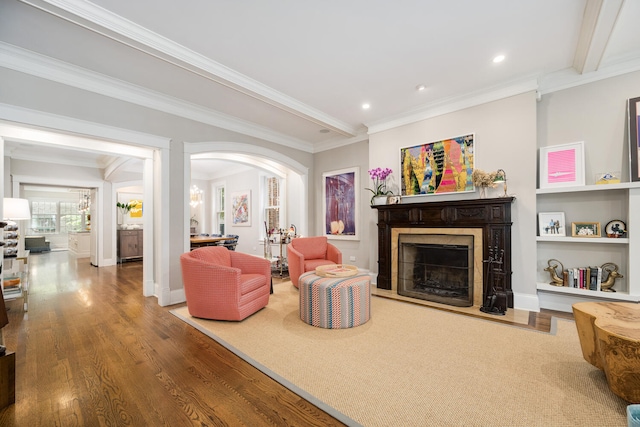 2131 W Schiller St, Chicago, IL 60622 - living area with a fireplace, wood finished floors, recessed lighting, crown molding, and arched walkways