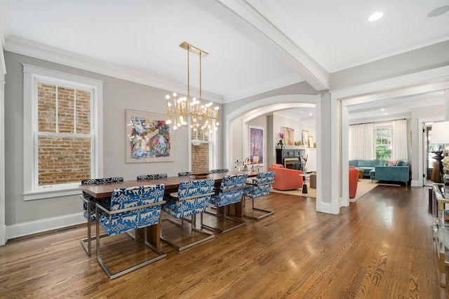 2131 W Schiller St, Chicago, IL 60622 - dining area with a fireplace, arched walkways, crown molding, wood finished floors, and recessed lighting
