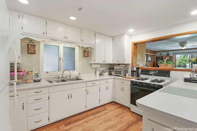 3914 N Richmond Rd, Johnsburg, IL 60051 - kitchen with white gas stove, tasteful backsplash, white cabinets, light wood finished floors, and recessed lighting