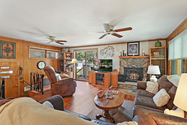 3914 N Richmond Rd, Johnsburg, IL 60051 - living area with a ceiling fan, wood finished floors, a fireplace, and wood walls